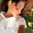 Belen Rodriguez sdraiata sul prato fiorito