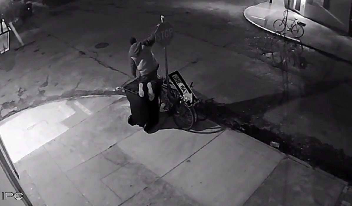 Ruba bicicletta smontando il cartello stradale