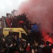 Soccer fans light flares and clamber atop Police vans before their Champions League, Semi Final First Leg soccer match between Liverpool and Roma, at Anfield in Liverpool, England, Tuesday April 24, 2018. (Peter Byrne/PA via AP) [CopyrightNotice: PA Wire]