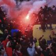 Soccer fans light flares and clamber atop Police vans before their Champions League, Semi Final First Leg soccer match at Anfield in Liverpool, England, Tuesday April 24, 2018. (Peter Byrne/PA via AP) [CopyrightNotice: PA Wire]